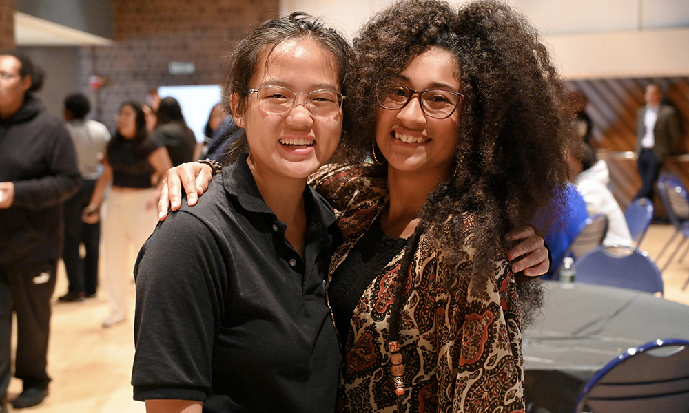 Two people smiling at the camera.