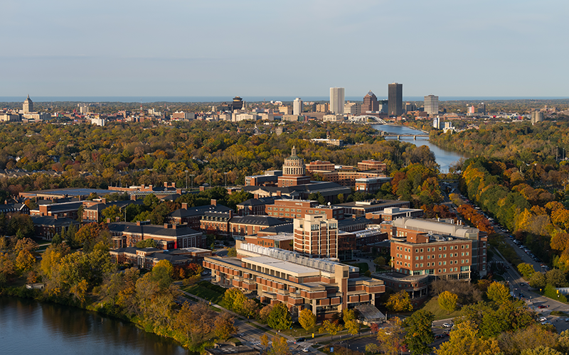 Aerial photo of River Campus and the Genesee River with downtown Rochester in the distance