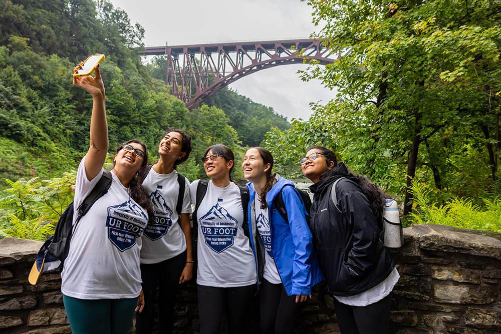 Students pose for a selfie in front of the Genesee Arch Bridge in Letchworth State Park during the 2025 UR FOOT program 