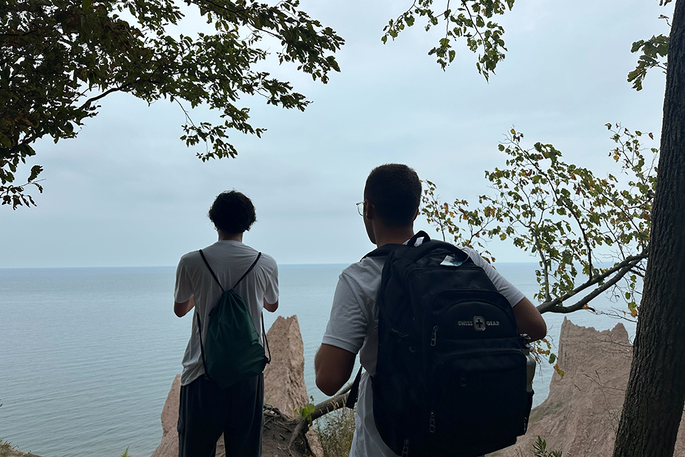 Students look out at the coastline at Chimney Bluffs State Park during the 2025 FOOT program