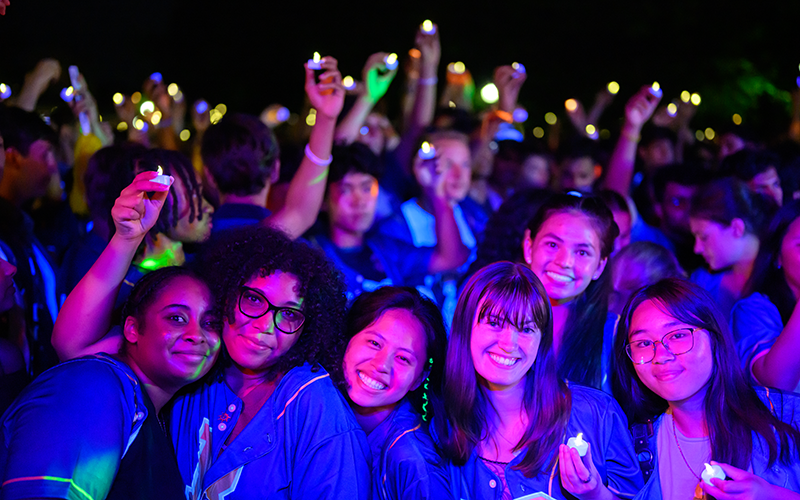 Students smile and pose for a photo at the Candlelight Ceremony during Fall 2026 Welcome Week