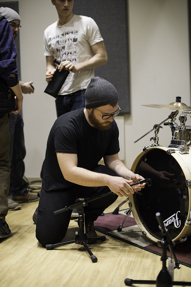 A student setting up equipment in the studio.