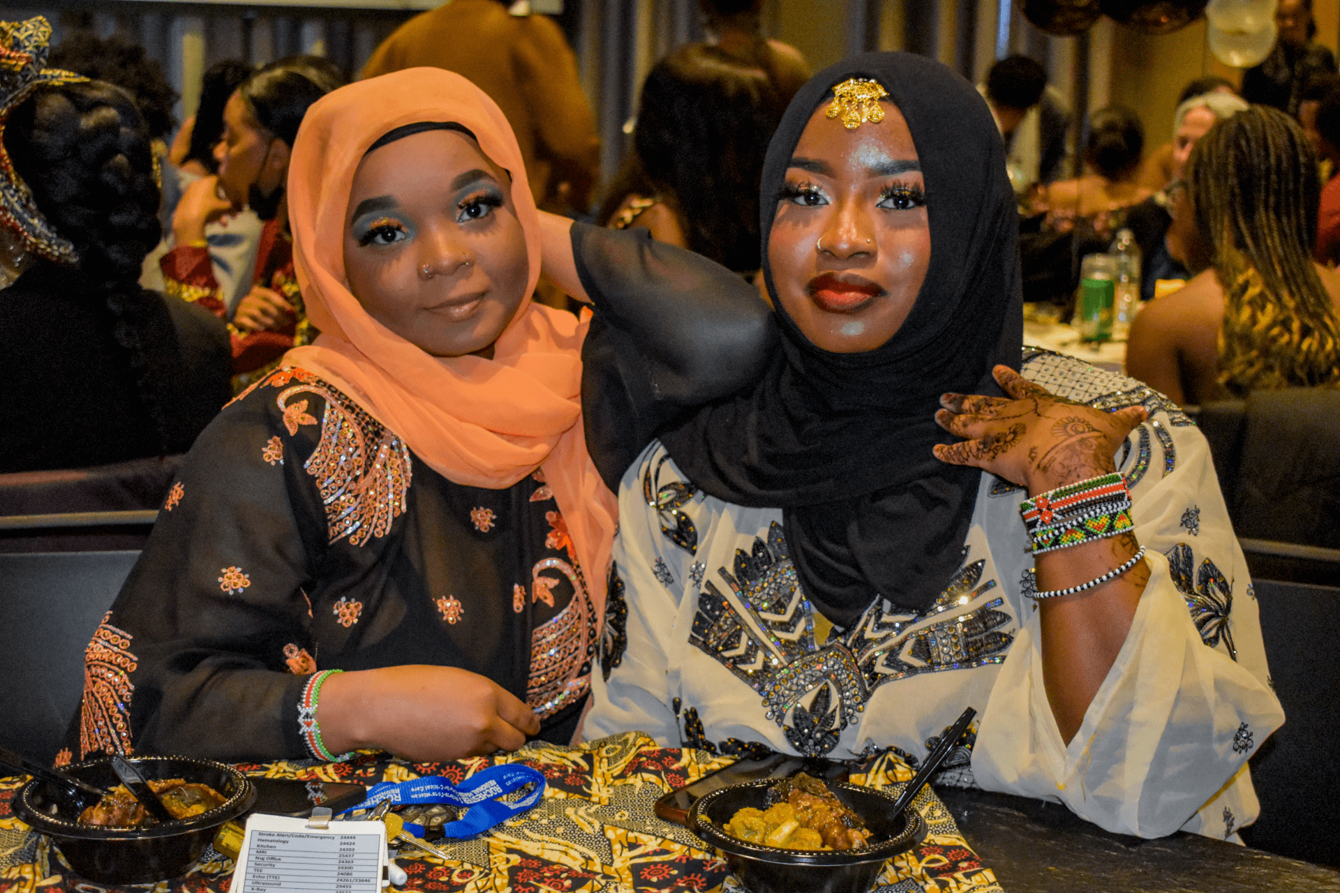 Two students sitting at an event with food