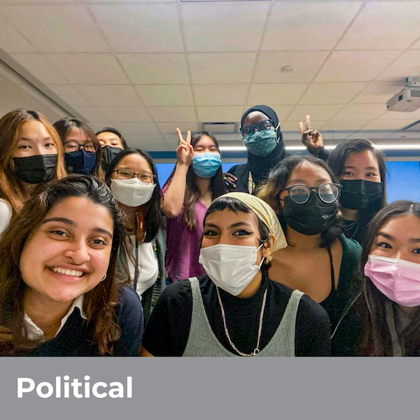 Political - Many students smiling masked in a classroom