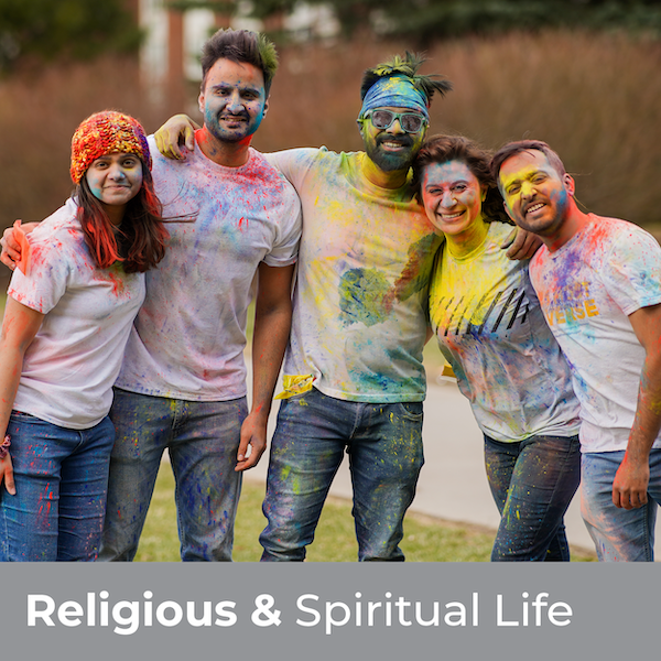 Religious & Spiritual Life - Five students covered in colorful powder and smiling