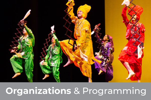 Organizations and Programming - Students dancing in wearing colorful garb