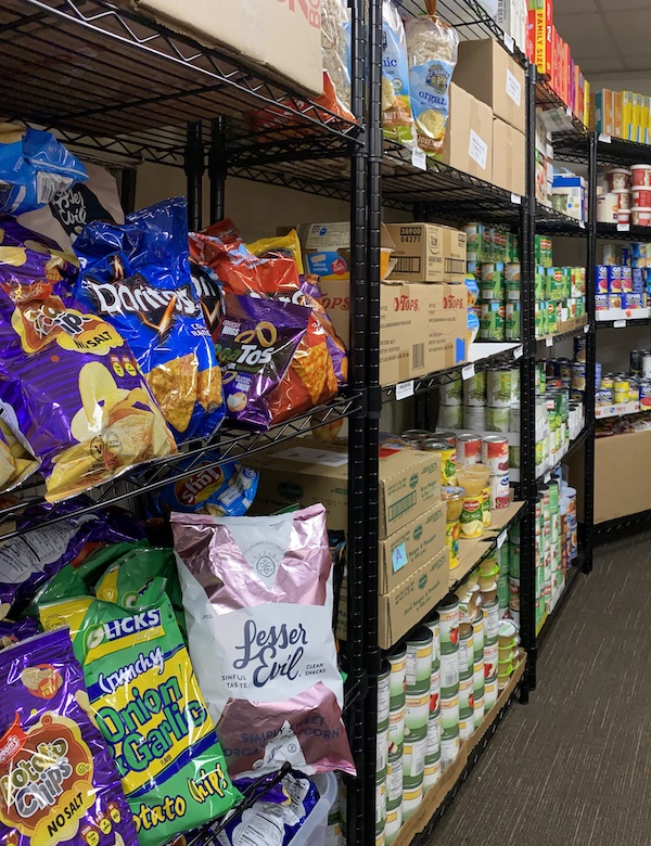 Food pantry shelves stocked with packaged goods