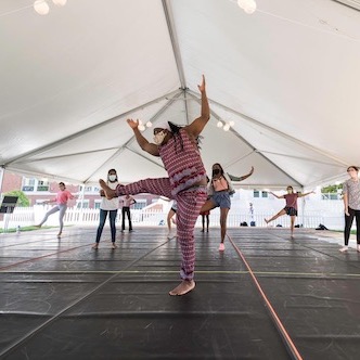 Group of students dancing in a large tent