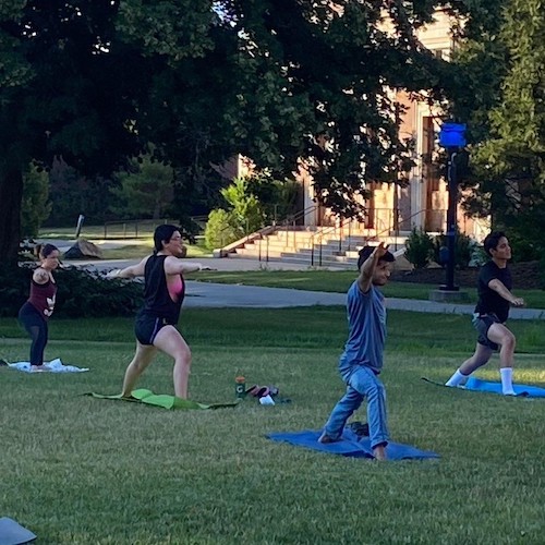 Students doing yoga outdoors