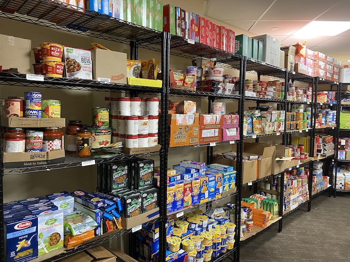 several shelves of dry good food items including cereals, chips, and granola bars