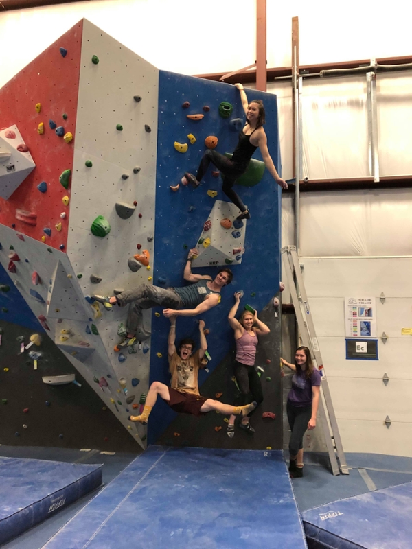 Students on a rock wall.