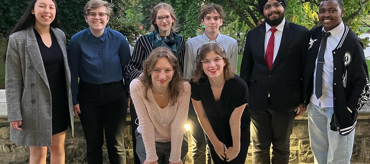 A group photo of the team smiling at the camera.