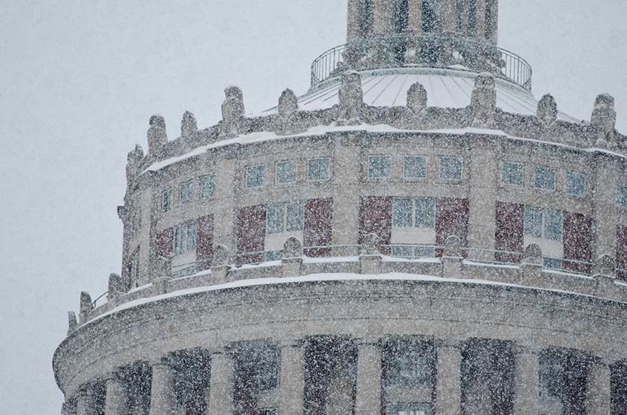 Snow falling in front of University of Rochester Rush Rhees Library