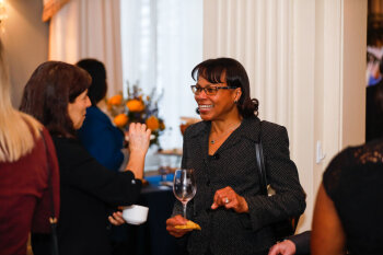 A candid photo of two women conversing at the George Eastman Circle Faculty & Staff Reception held on March 30, 2023 within Rochester New York.