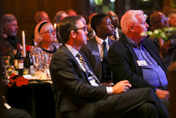 Attendees seated listening attentively