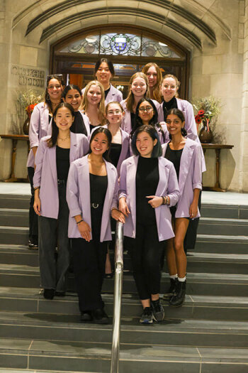 A group photo of thirteen women posing