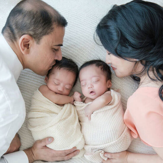 Sherry Tsang, with her twin boys and husband.
