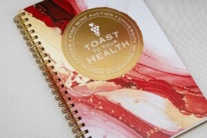 toast to your health notebook with red and gold swirls