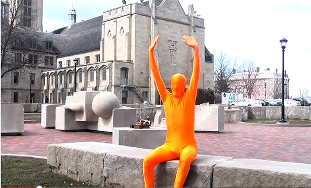 orange guy stretching in front of MAG building