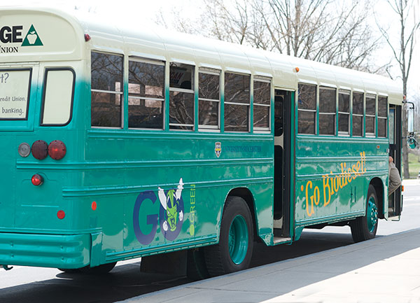 teal colored bus with "Go Biodiesel" and "Go Green" signage