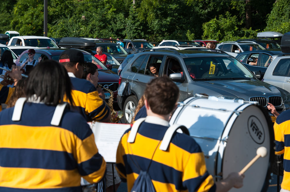 pep band musicians perform in parking lot