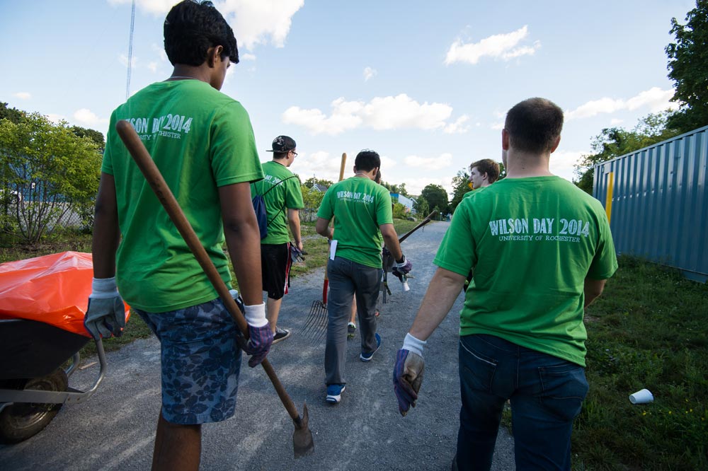 students walking down a road, the backs of their t-shirts read Wilson Day 2014