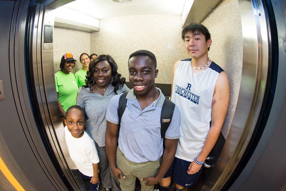 elevator packed with smiling students and families
