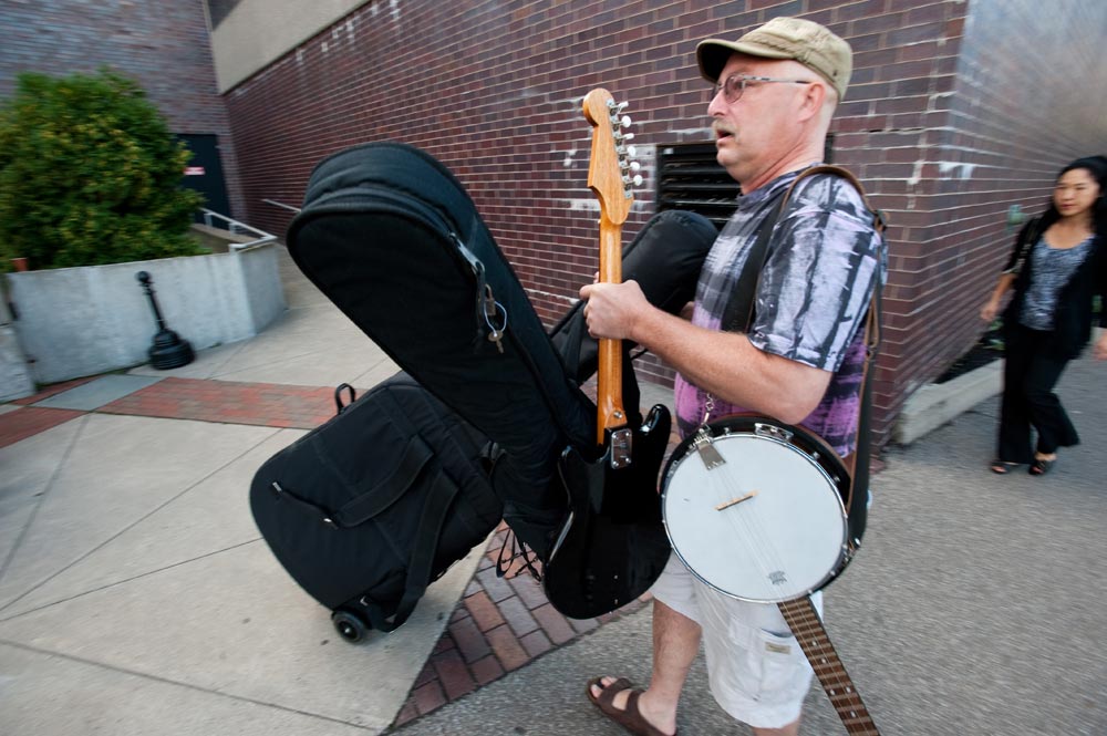 father carries a banjo and other instruments