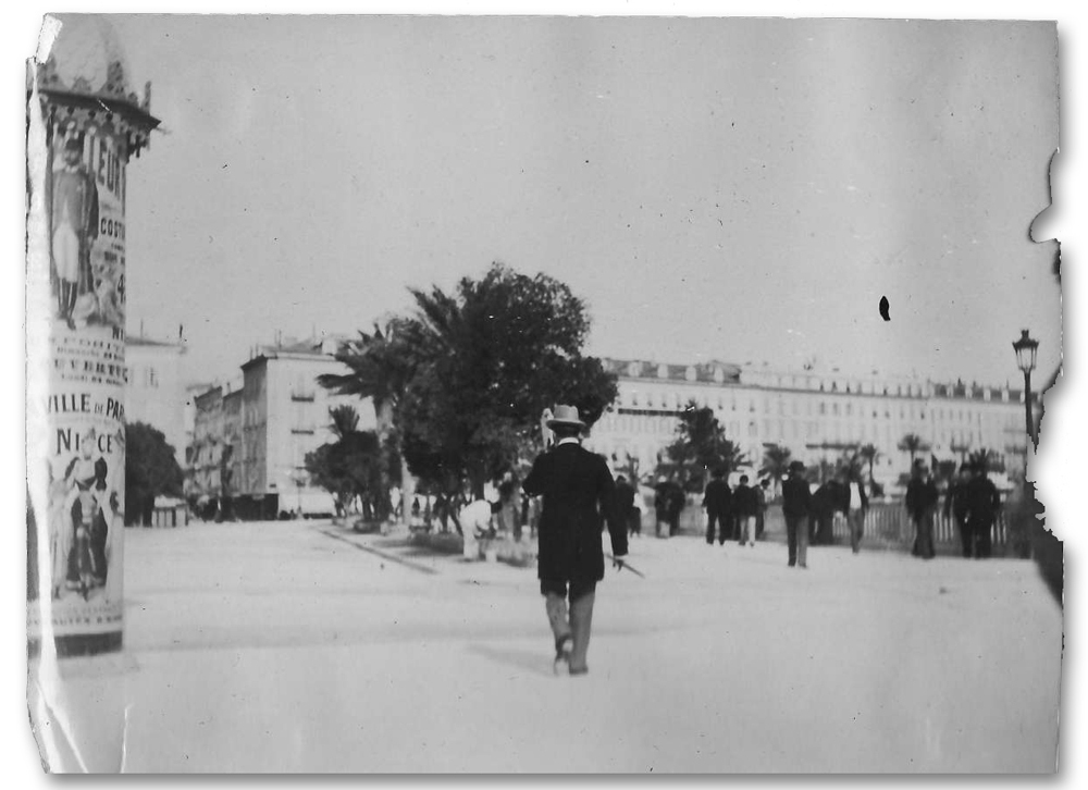 historic photograph shows man in top hat walking away down a crowded street