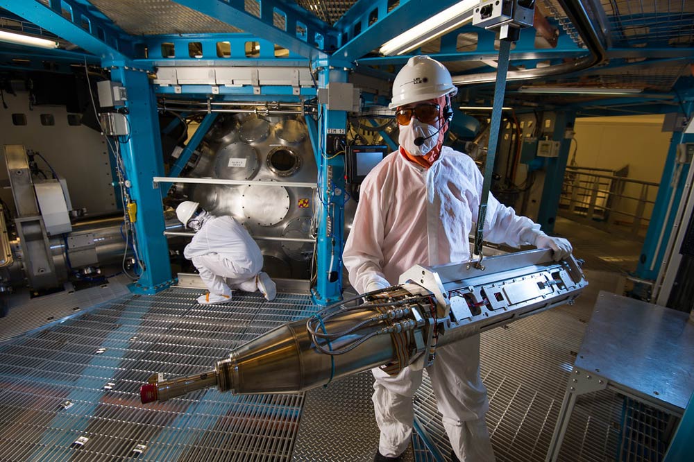 technicians working in clean suits in the Laser Lab