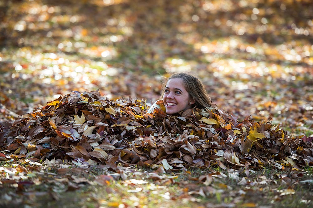 student in leaves