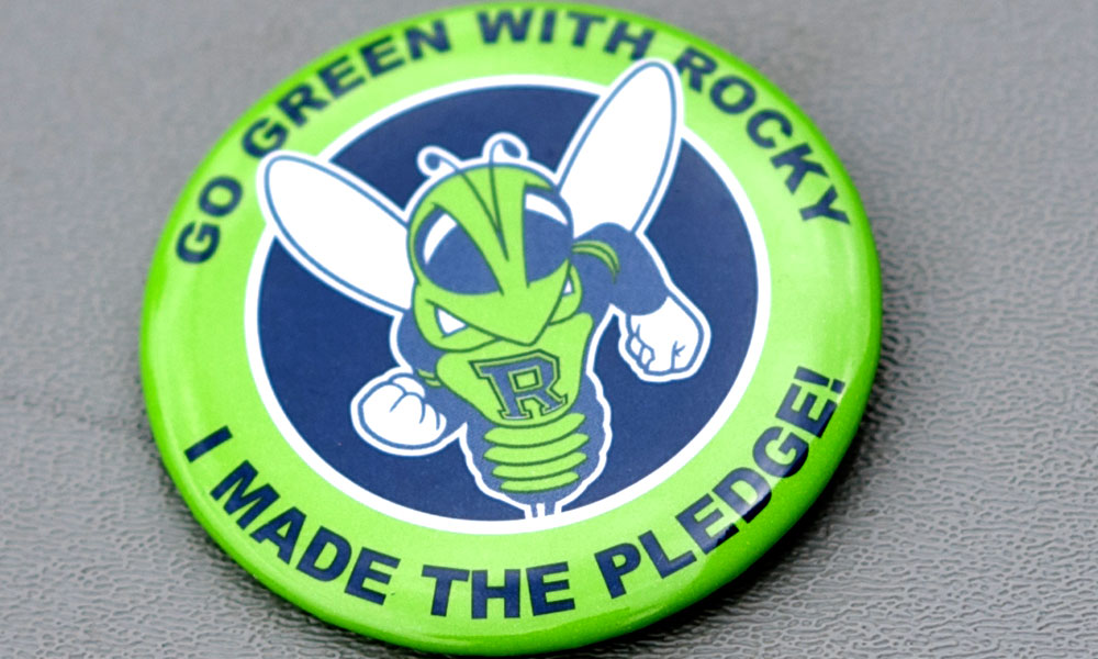 Button that reads GO GREEN WITH ROCKY, I MADE THE PLEDGE.