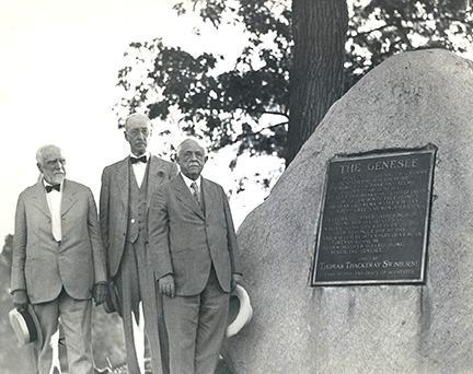 historic photo of men standing next to the Swinburn Rock