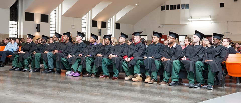 group of graduates sit in a row
