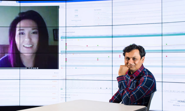 Ehsan Hoque in front of computer screen with inset of another person's face and data science content