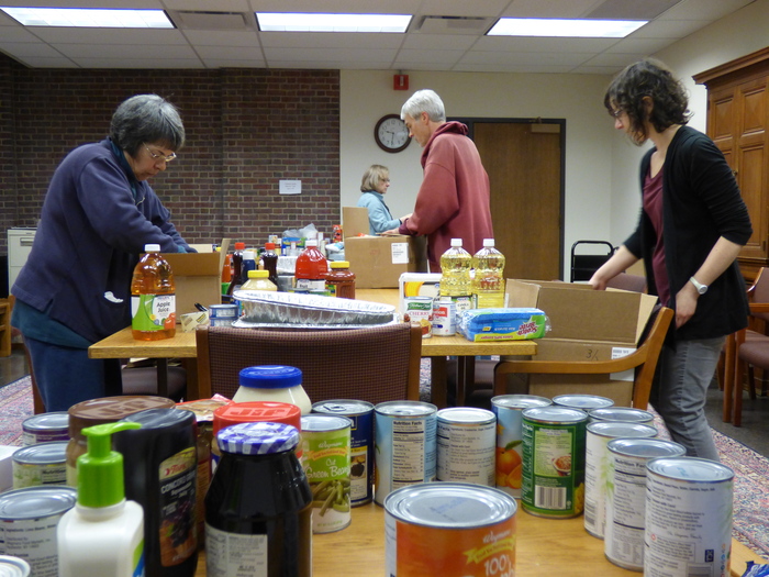 River Campus Libraries staff members (from left to right) Patricia Curran, Jennifer Bowen, David Hull, and Esther Arnold pack food donations to be delivered to Baden Street Settlement families for Thanksgiving.