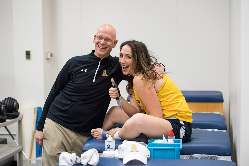 athletic trainer and student give a thumbs up