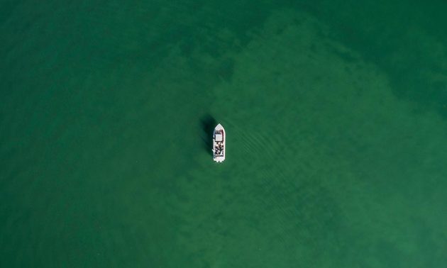 aerial shot of boat on a large body of water