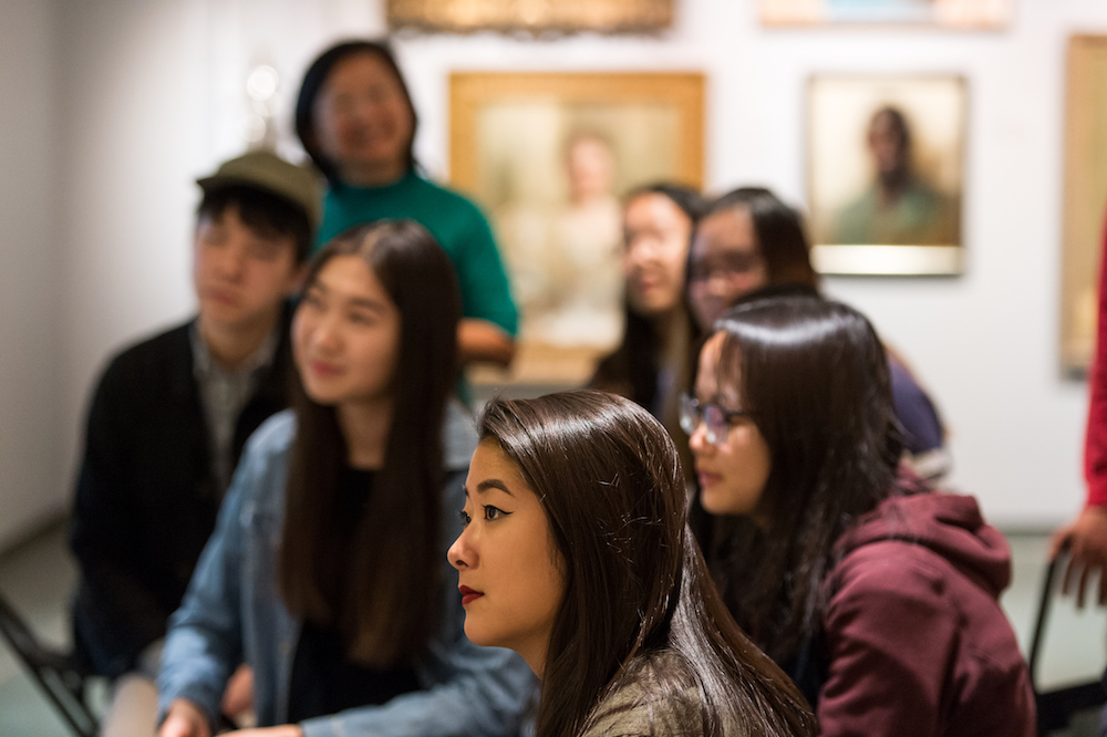 Sarah Pursell '20 listens to Andrew Cappetta, the Memorial Art Gallery’s assistant curator of academic programs, during a class visit to the museum. (University photo / J. Adam Fenster)