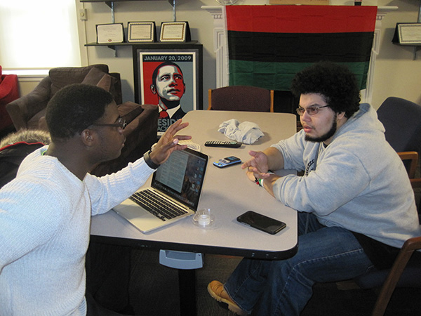 two students talking at a table