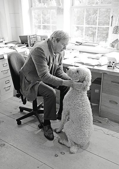 Galway Kinnell in his office with his dog