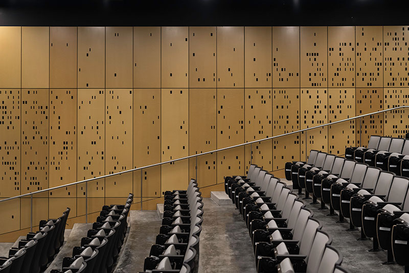 auditorium with walls made to look like computer punch cards