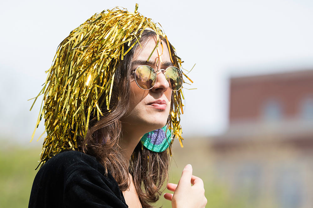 girl wearing a gold pompom on her head