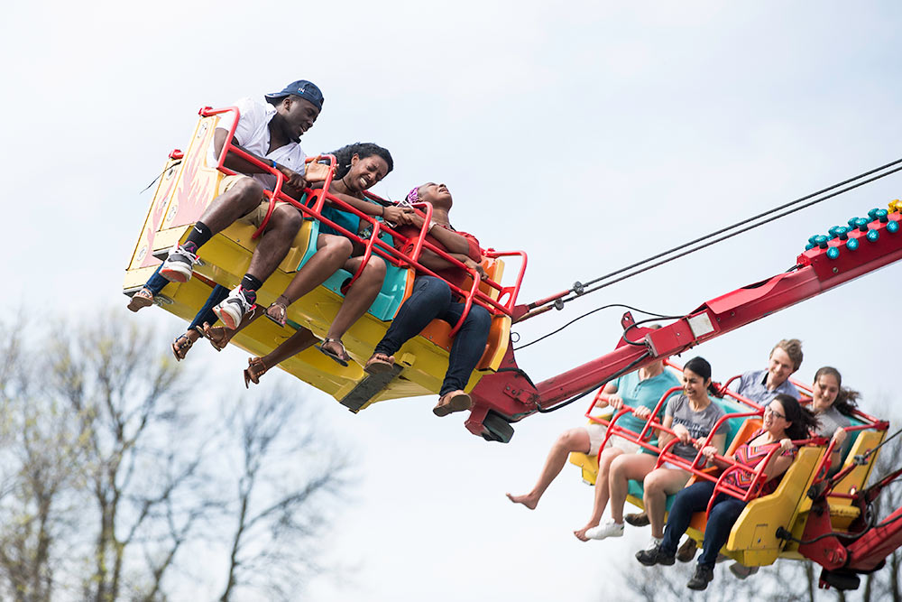 people on a spin ride, with one not looking happy