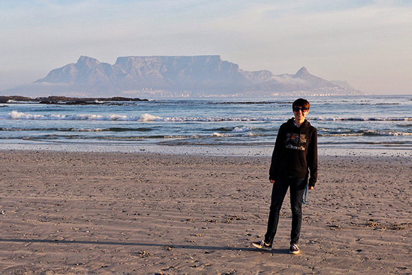 student standing on a beach in South Africa