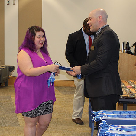 woman receiving an award from man