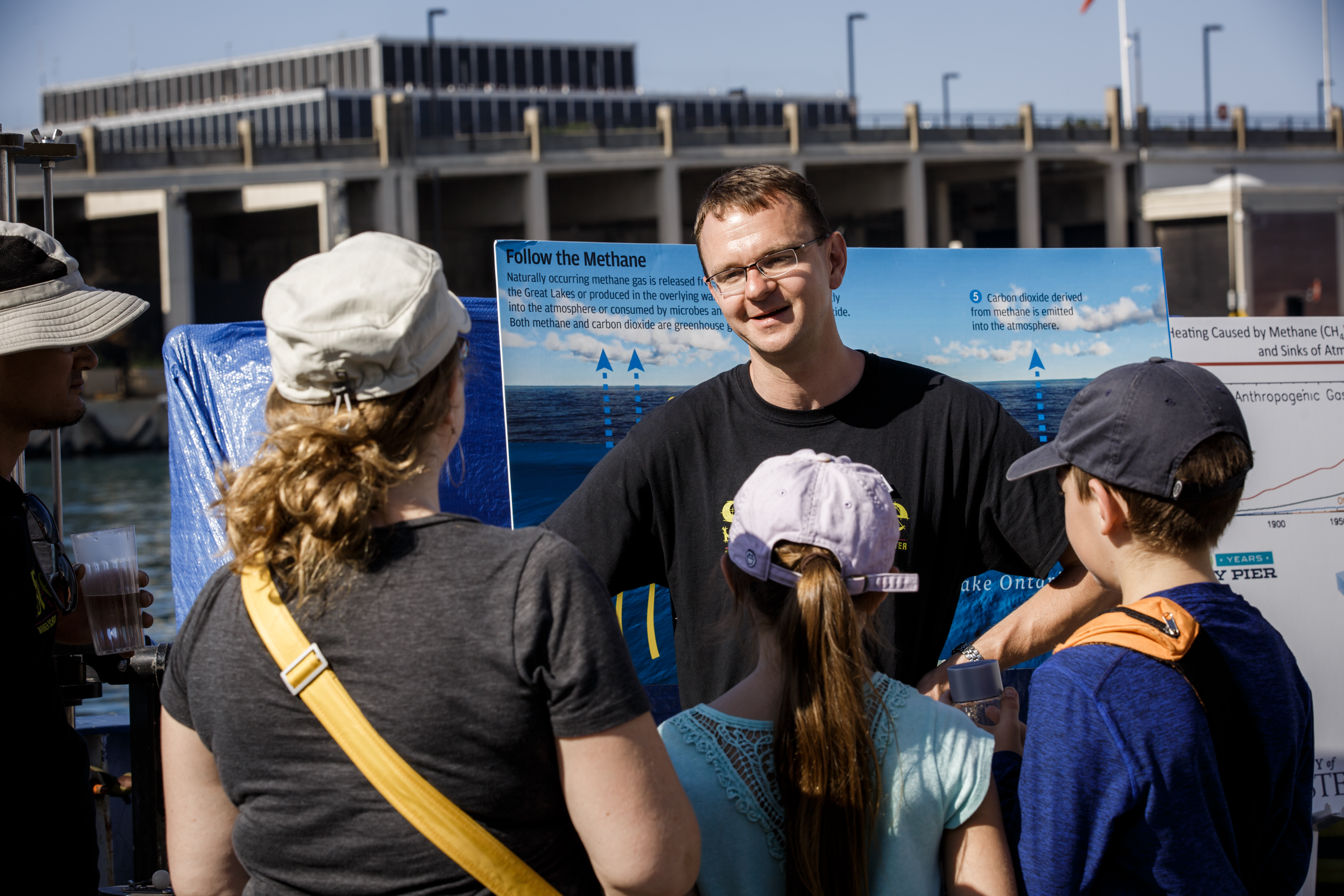 Researchers talks to kids on the pier