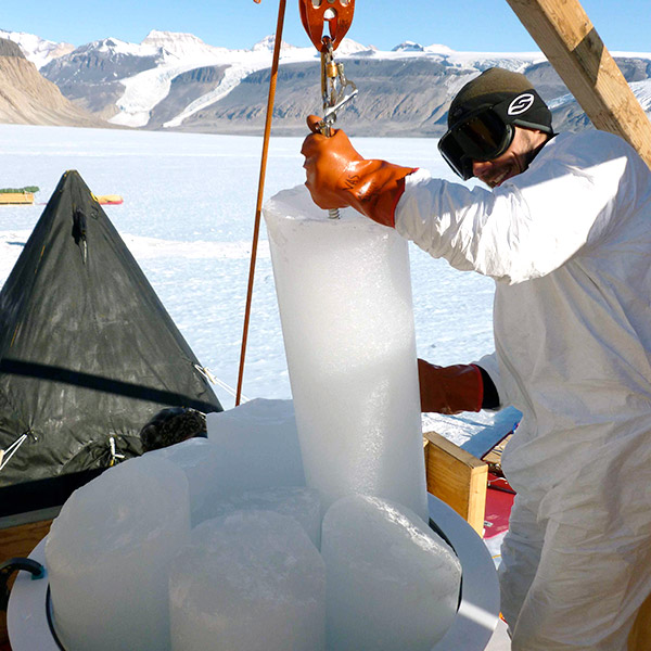 Vasilii Petrenko lifts a large ice core sample on a crane