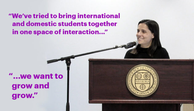 Teresa Valdez behind a podium at the Language Center, with the words "We’ve tried to bring international and domestic students together in one space of interaction ...We want to grow and grow.