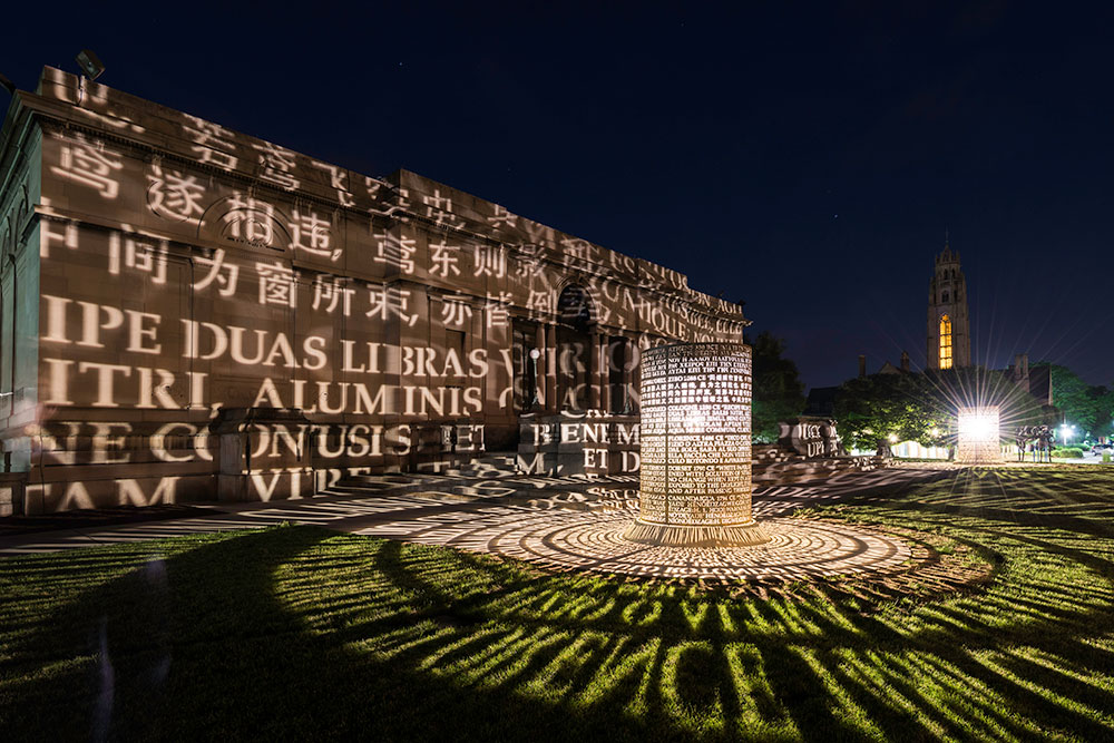 outdoor exhibit at Memorial Art Gallery, with words projected in light onto the building